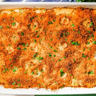 Baked turkey tetrazzini in a large white rectangular casserole dish with chopped parsley sprinkled on top